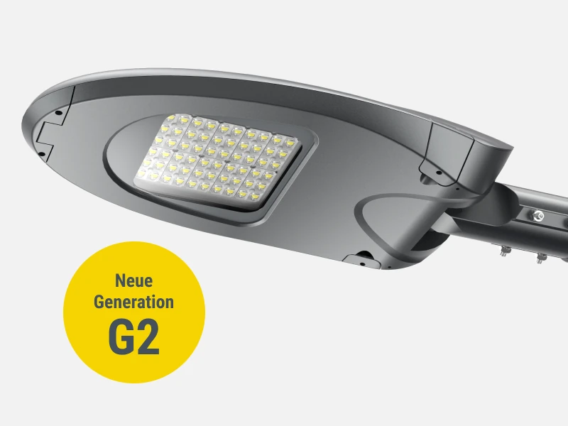 Moderne LED-Straßenleuchte in grauem Gehäuse mit ovaler Form und zentralem LED-Modul, seitlich montiert, daneben gelber Kreis mit der Aufschrift „Neue Generation G2“.